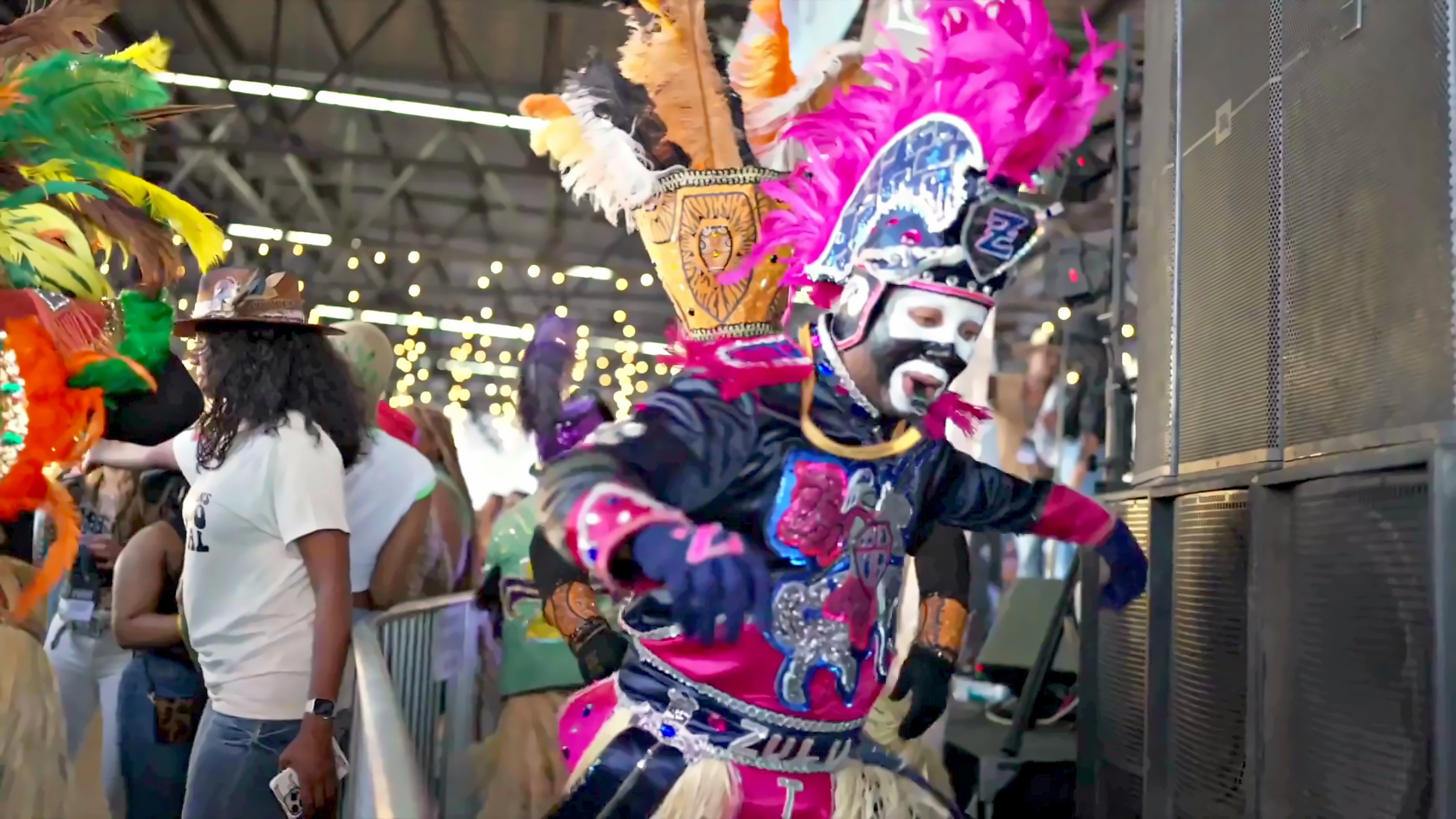 A Mardi Gras Indian in a full beaded and feathered suit at the festival