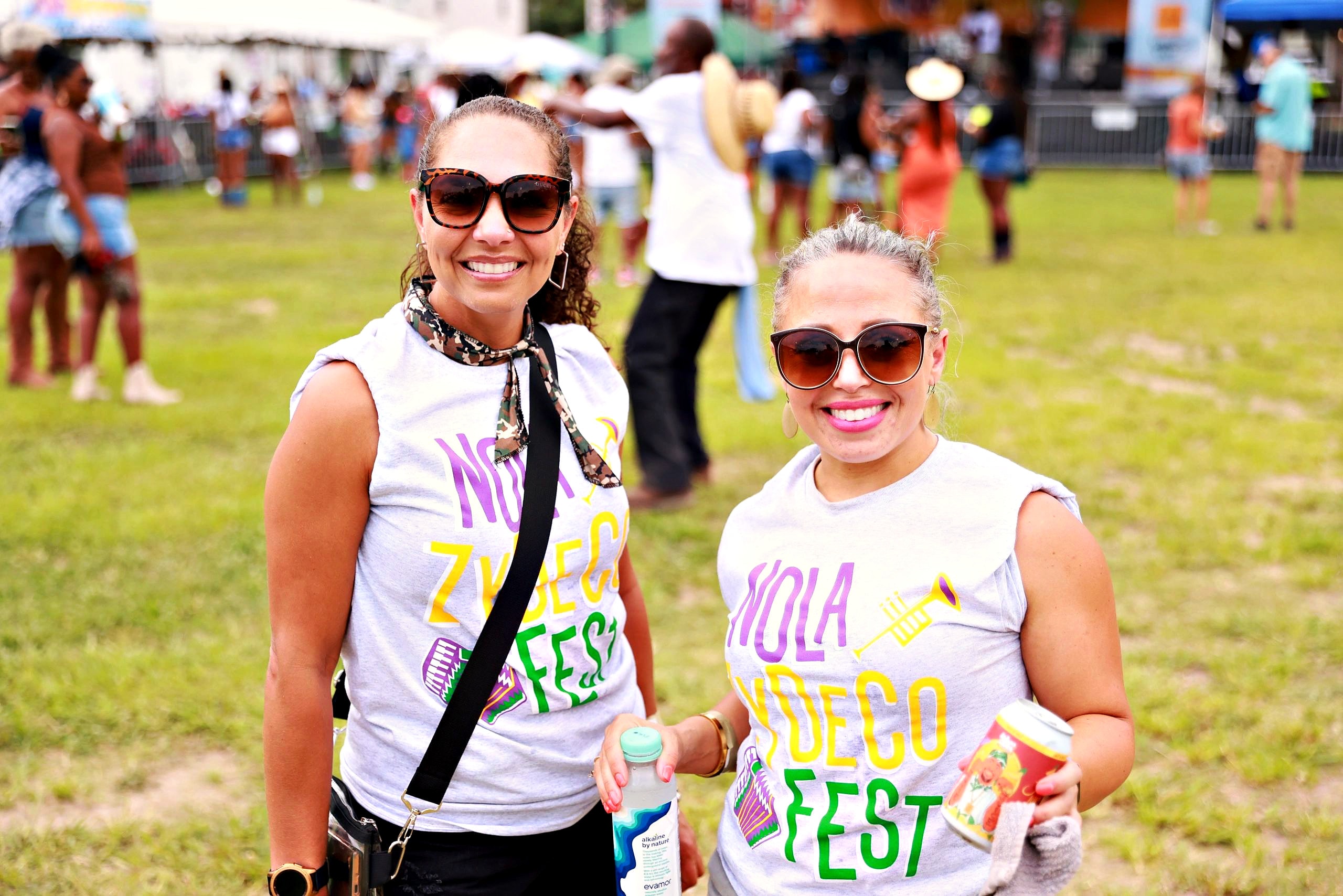 Two festivalgoers in NOLA Zydeco Fest shirts
