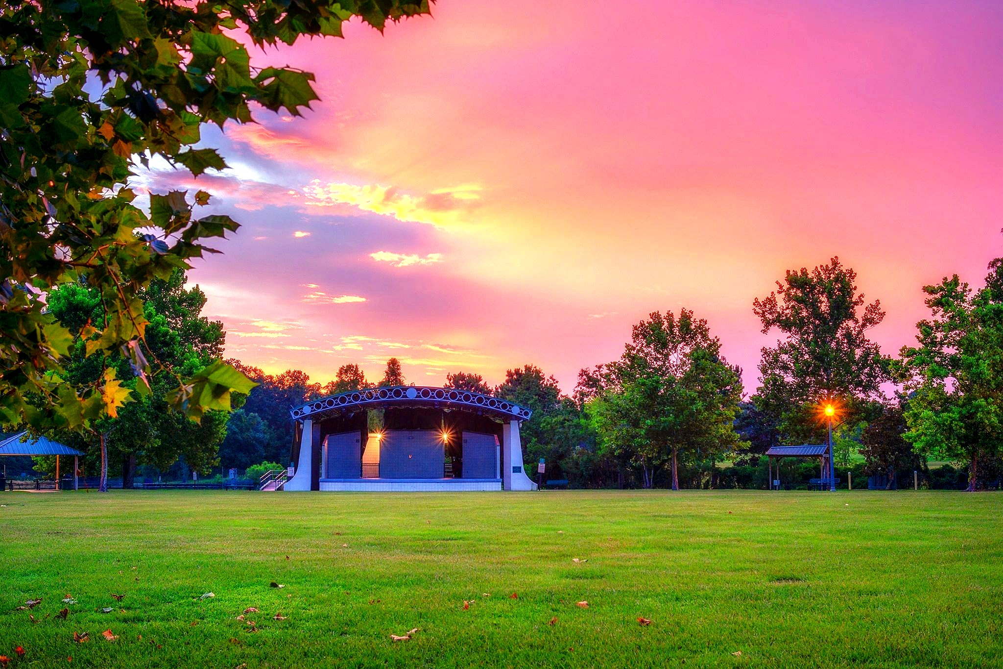 The Heritage Park stage in Slidell under a pink and orange sunset