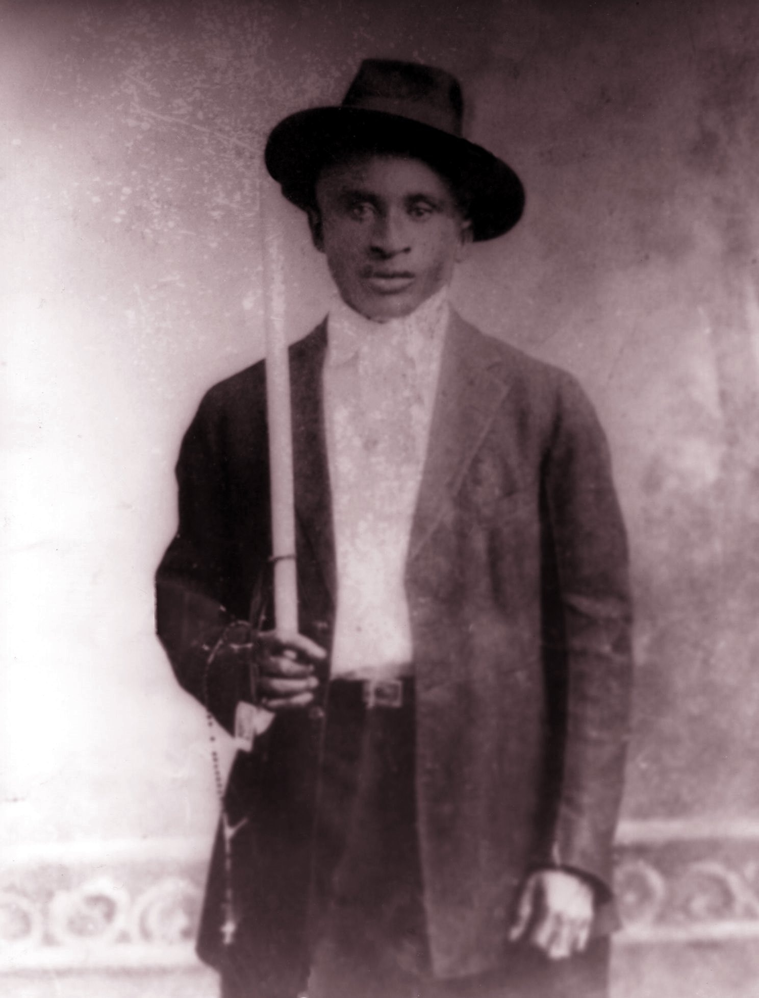 Portrait of Creole accordionist Amédé Ardoin in a hat and suit