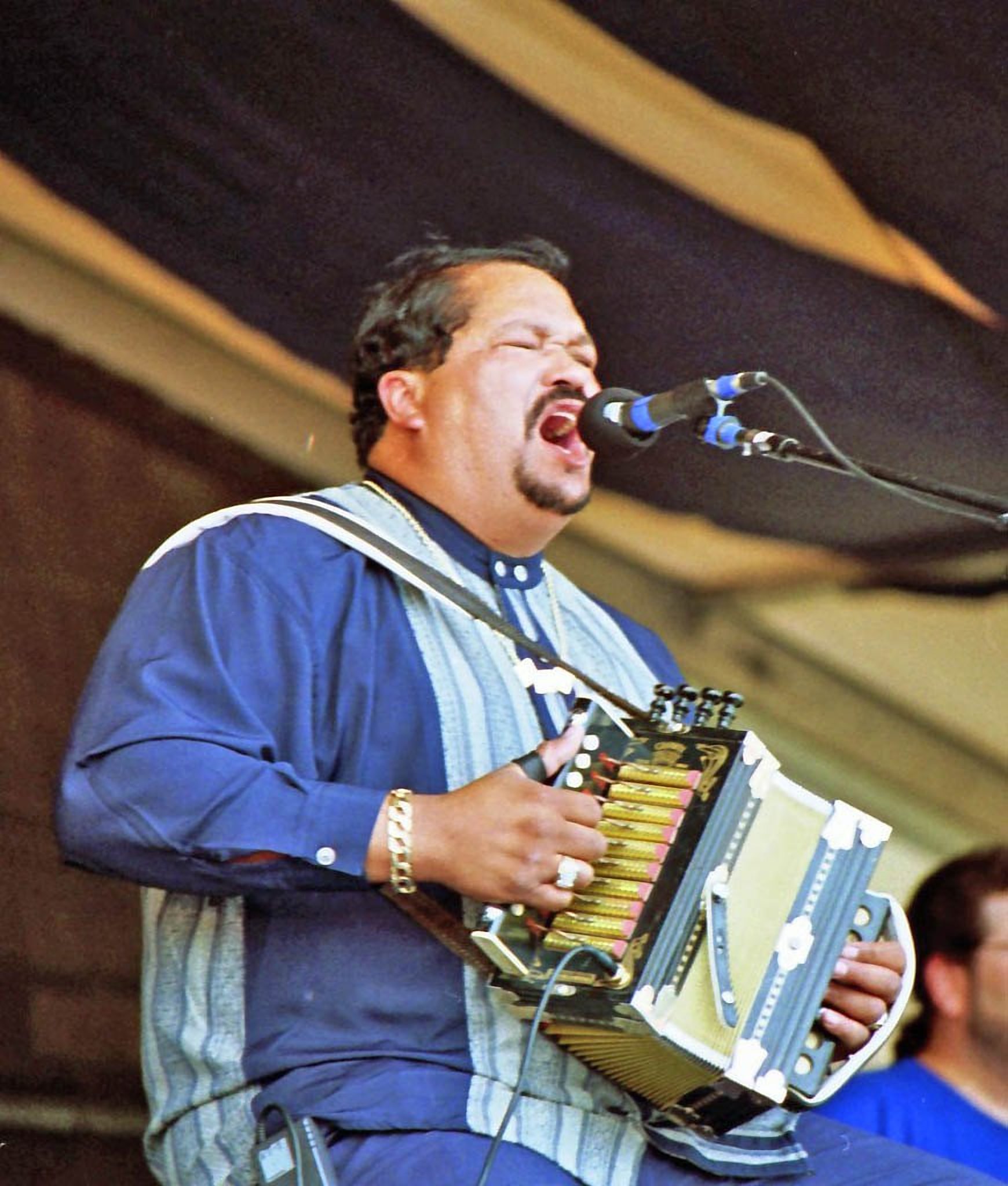 Beau Jocque singing and playing accordion on a festival stage, 1997