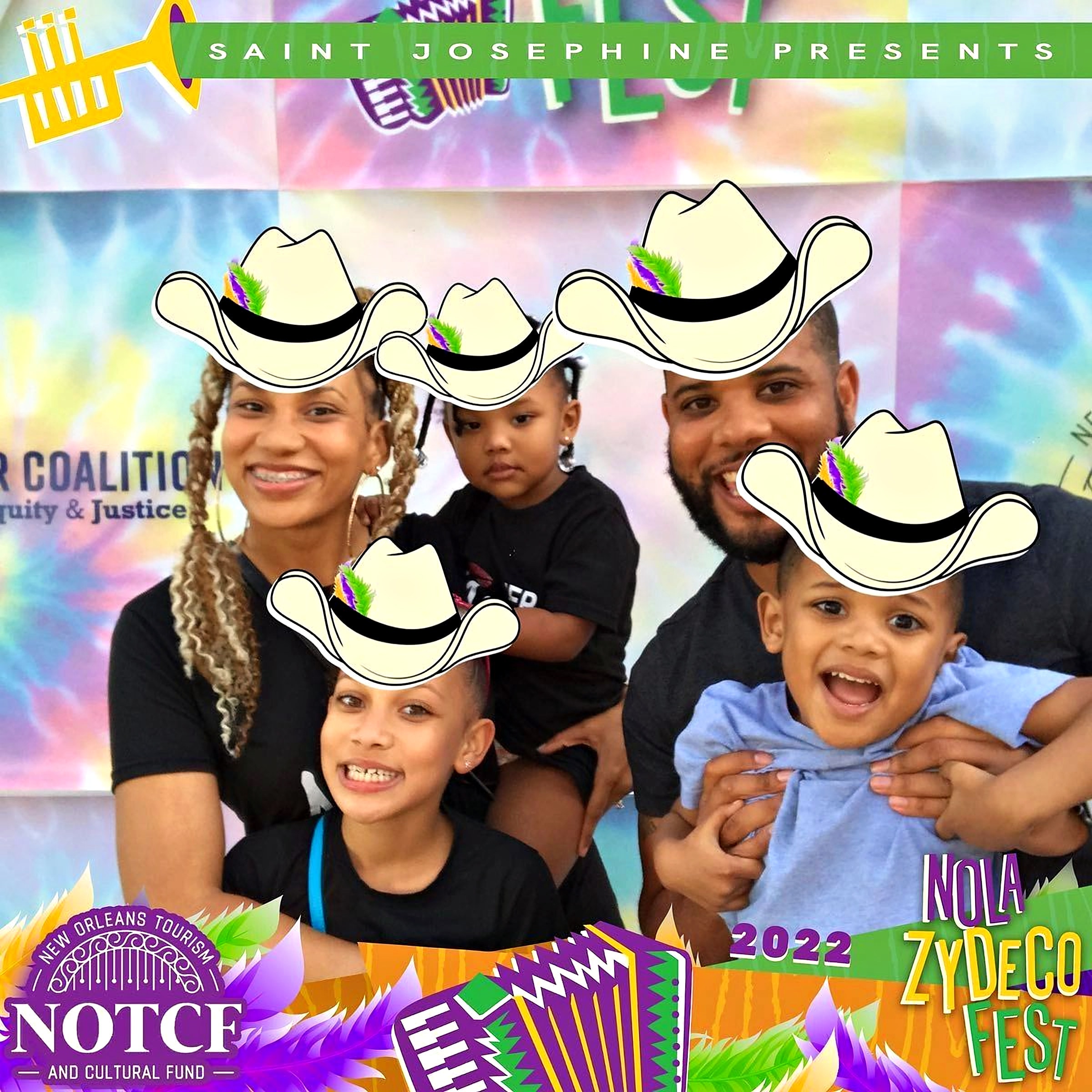 A family in cartoon cowboy hats at the festival photo booth