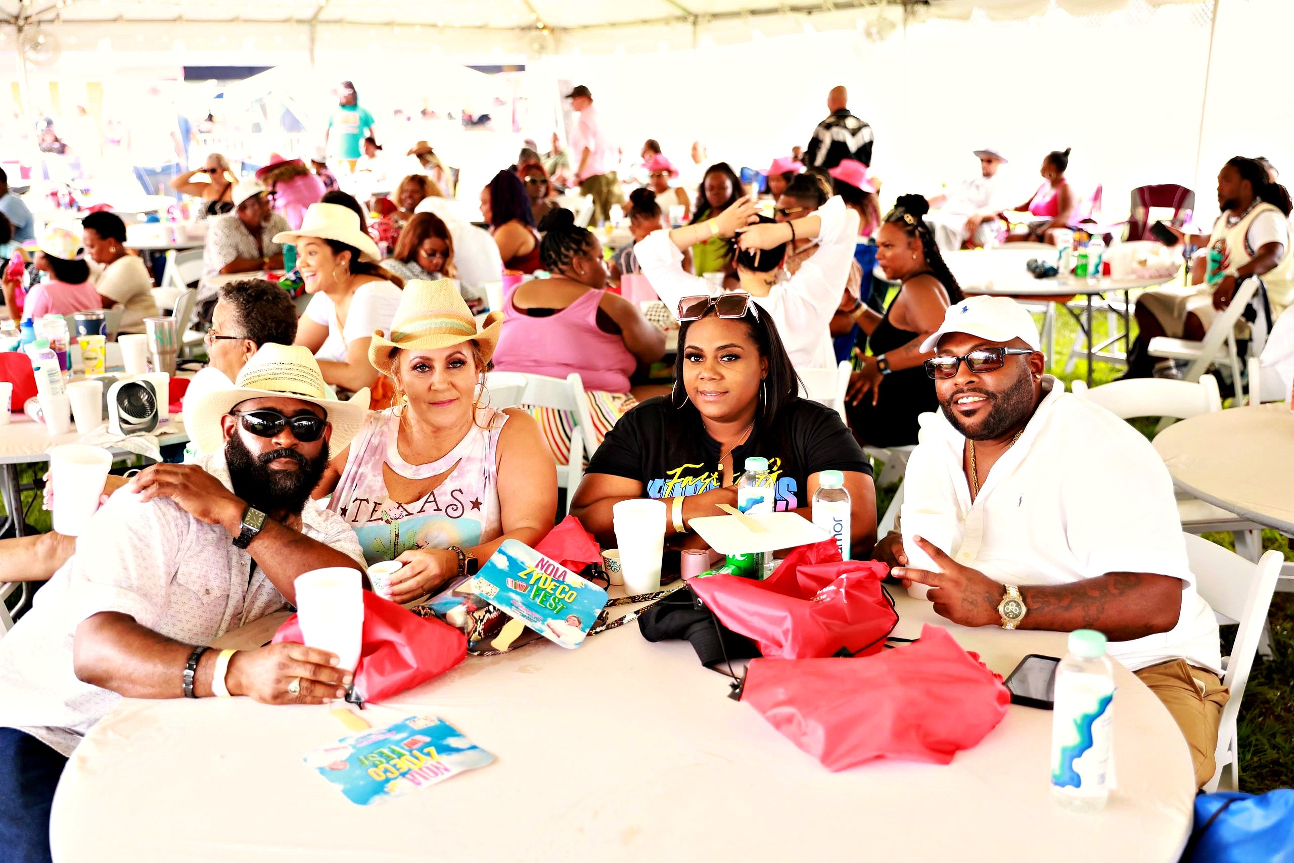 Friends at a VIP table under the festival tent
